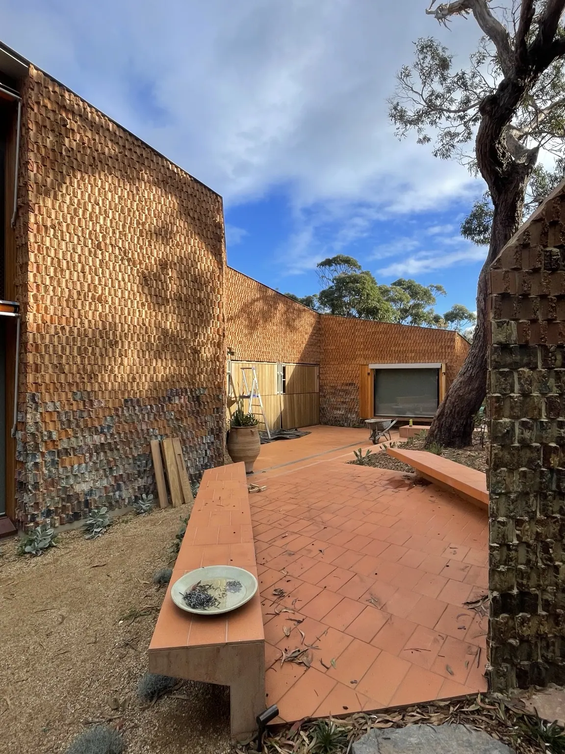 Courtyard with textured terracotta masonry walls